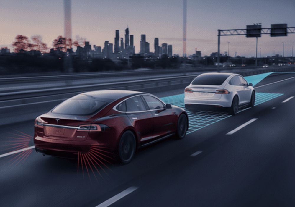 red-and-white-tesla-on-highway-showing-ADAS-working-Aliotos-Auto-Body-San-Francisco