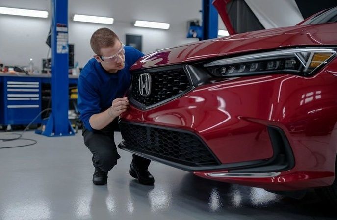 Auto-Body-technician-looking-at-a-Honda-Sedan-for-repair-at-Aliotos-Auto-Body-San-Francisco-Bay